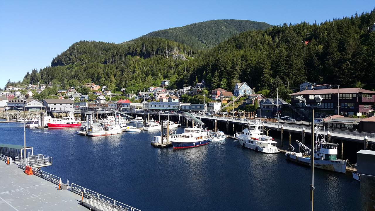 Several small fishing boats docked in front of historic homes in downtown Ketchikan