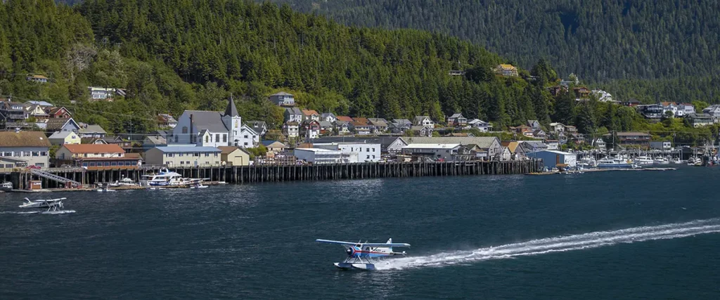 A float plane Landing in the Ocean on front of downtown Ketchikan