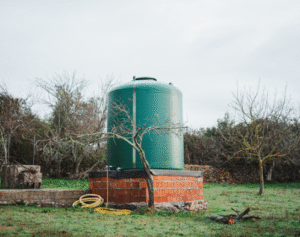 A standalone cistern in a field with an insulated cover.