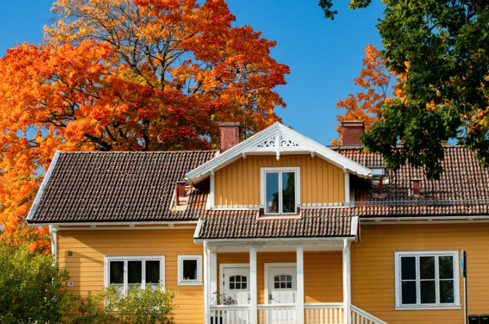 A yellow home with orange trees